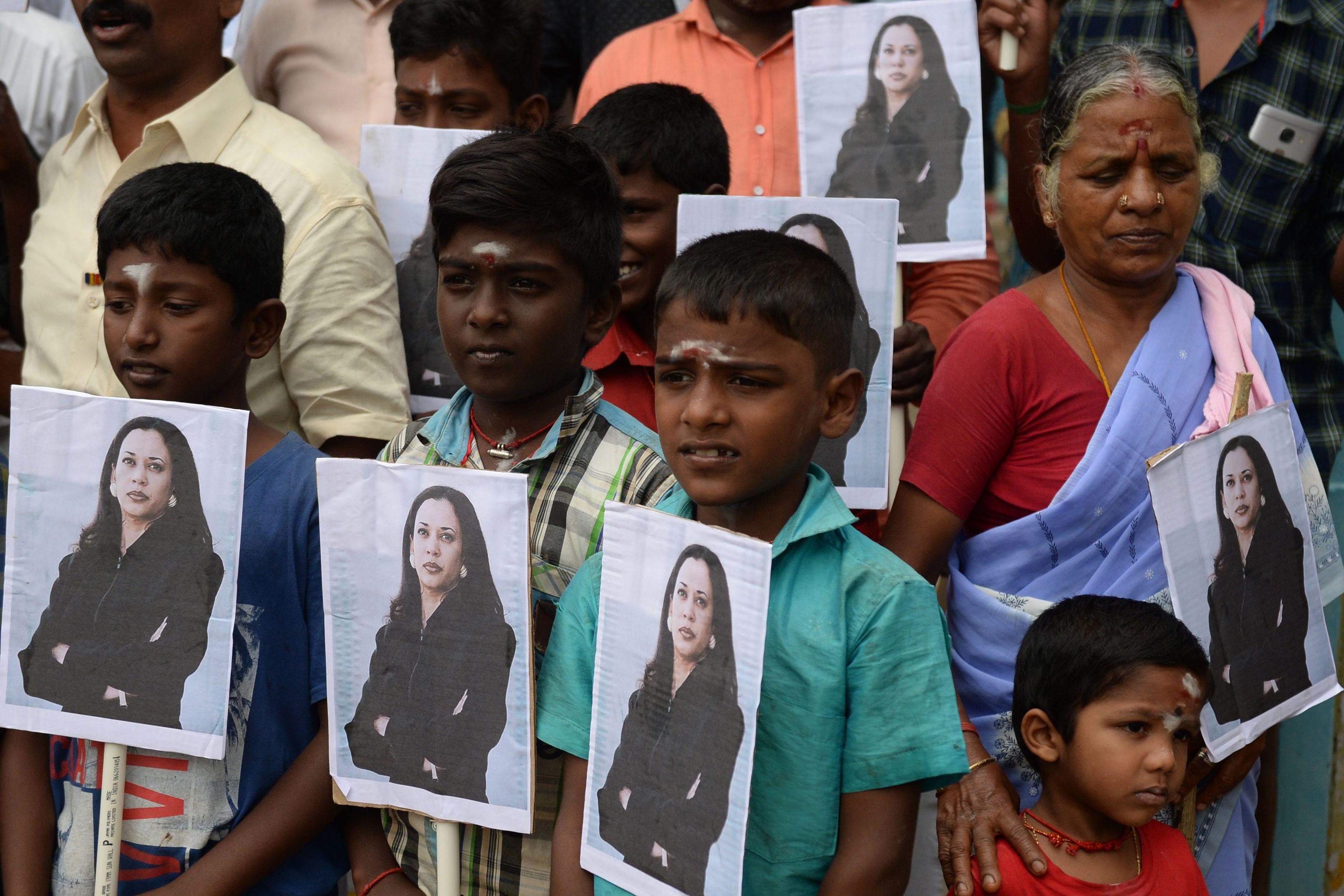 Villagers pose holding photos of US Vice President-elect Kamala Harris at her ancestral village of Thulasendrapuram in the southern Indian state of Tamil Nadu. (AP)