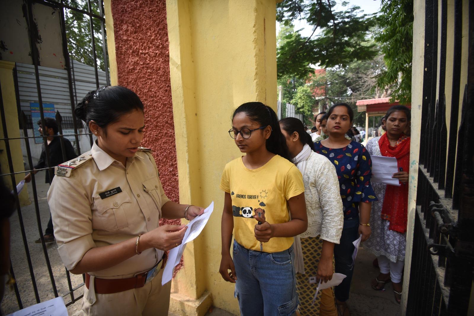 Security personnel check aspirants'' documents outside Patna's Magadh Mahila College examination center. (Photo by Santosh Kumar)