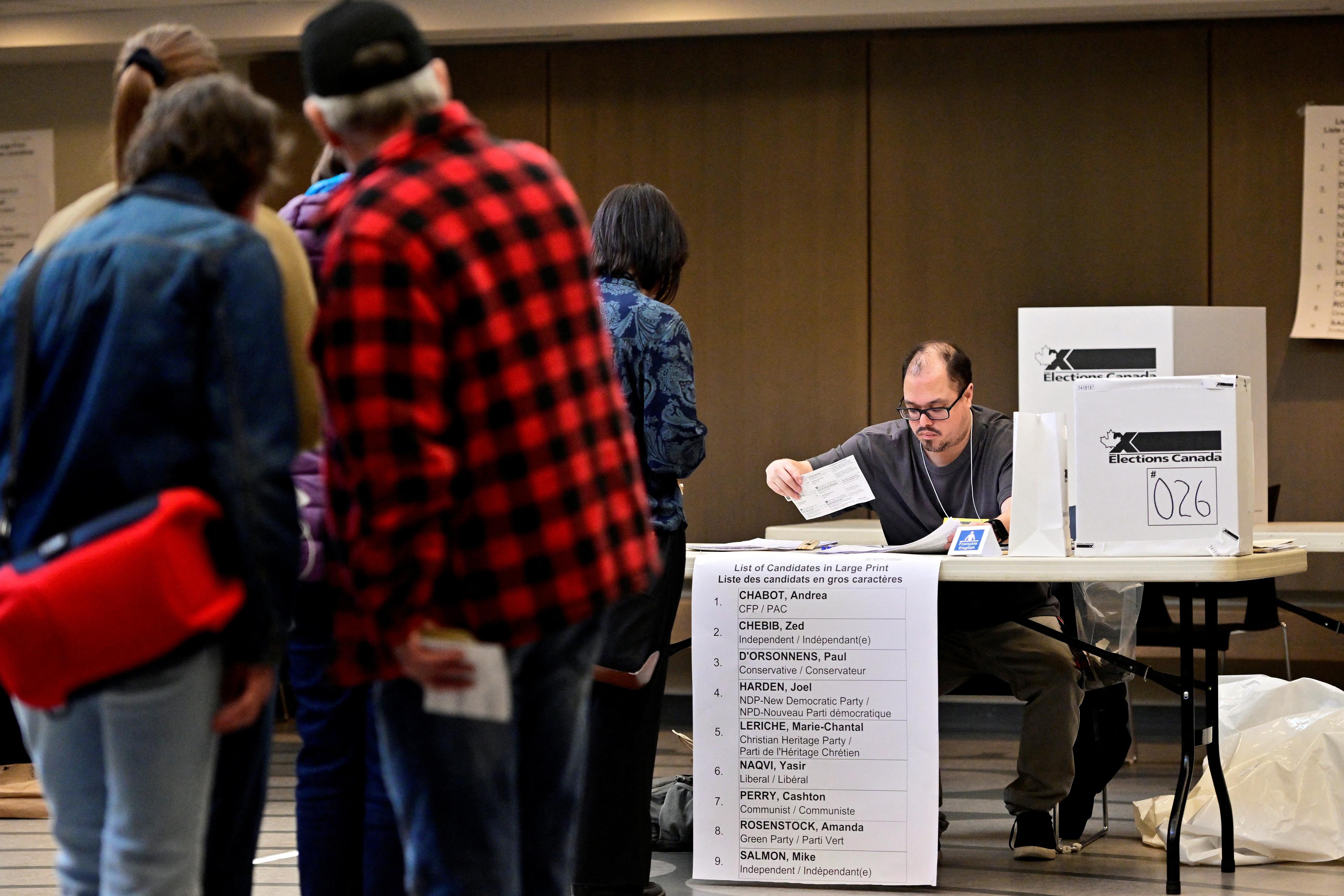 Voters inside a polling station in Ottawa Centre on the day of the federal election in Ottawa, Ontario, Canada April 28, 2025.  (REUTERS)