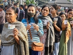 Voters show their identification cards as they wait in a queue to cast their votes at a polling booth during the Meghalaya assembly elections in Ri Bhoi district on Monday, (PTI) Voters show their identification cards as they wait in a queue to cast their votes at a polling booth during the Meghalaya assembly elections in Ri Bhoi district on Monday, (PTI)