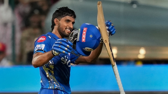 Tilak Varma acknowledges the crowd as he walks back after the end of the Mumbai Indians inning during the IPL 2023 match against Royal Challengers Bangalore(PTI)
