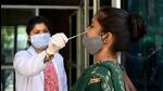 A health worker collects a swab sample at the District Hospital in Sector 30 in Noida on Monday. (Sunil Ghosh/HT Photo) A health worker collects a swab sample at the District Hospital in Sector 30 in Noida on Monday. (Sunil Ghosh/HT Photo)