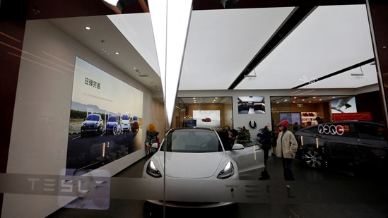 Visitors check a Tesla Model 3 car next to a Model Y displayed at a showroom of the U.S. electric vehicle (EV) maker in Beijing, China February 4, 2023. REUTERS/Florence Lo(REUTERS)