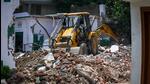 A bulldozer demolishing an illegal structure at a Bengali market madrasa during a drive by the land and development office (L&DO). (Raj K Raj/HT Photo) A bulldozer demolishing an illegal structure at a Bengali market madrasa during a drive by the land and development office (L&DO). (Raj K Raj/HT Photo)