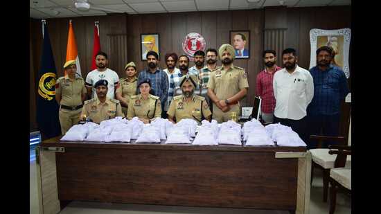 The police with the seized consignment in Fazilka. (HT Photo) The police with the seized consignment in Fazilka. (HT Photo)