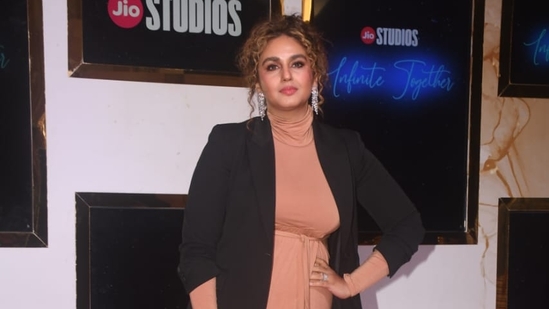 Huma Qureshi sported coloured hair as she arrived in a beige dress paired with a long blazer at the event. She will next be see as late chef Tarla Dalal in her biopic and in Pooja Meri Jaan. (Varinder Chawla)