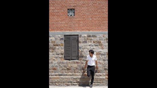 Not another brick in the wall as Koul strikes a pose as he tours his alma materR. Not another brick in the wall as Koul strikes a pose as he tours his alma materR.