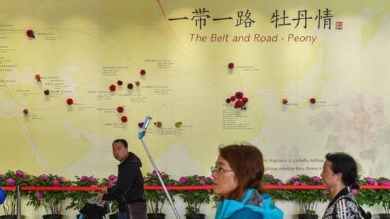 In this file photo, visitors walk past a wall with a map showing the Belt and Road Initiative (BRI) countries, at an exhibition in Beijing, China. In this file photo, visitors walk past a wall with a map showing the Belt and Road Initiative (BRI) countries, at an exhibition in Beijing, China.