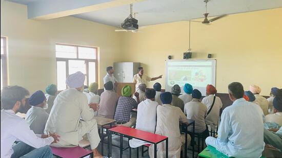 The officials and employees of the water resources department organising awareness camp to encourage farmers to use canal water for irrigation purposes. (HT Photo) The officials and employees of the water resources department organising awareness camp to encourage farmers to use canal water for irrigation purposes. (HT Photo)