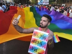 Same sex marriage: A supporter of the LGBT community takes a selfie with a rainbow flag. (Representational image) Same sex marriage: A supporter of the LGBT community takes a selfie with a rainbow flag. (Representational image)