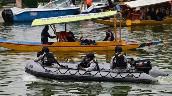 Indian Navy's Marine Commandos intensify patrols on the serene waters of Dal Lake in Srinagar, as security fortification commences in anticipation of the high-profile G20 Tourism Working Group meeting in Jammu and Kashmir, hosting delegates from G20 nations.(Waseem Andrabi/HT Photo)
