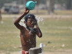 A slum kid cools off on a hot day at a public tap. A slum kid cools off on a hot day at a public tap.