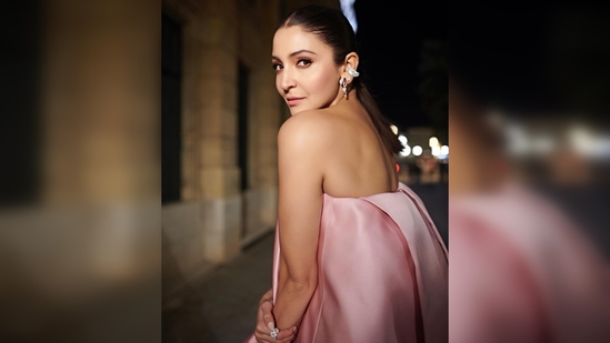Anushka Sharma's day two look comprised of a pink strapless top featuring a long train and bling black pants. (Instagram/@anushkasharma)