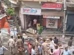 Police personnel standing at the spot where the balcony collapsed in Ahmedabad's Dariapur area. (Twitter/PTI) Police personnel standing at the spot where the balcony collapsed in Ahmedabad's Dariapur area. (Twitter/PTI)
