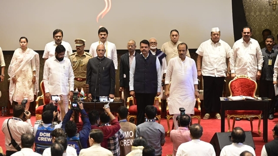 Newly appointed ministers during the national anthem after the oath-taking ceremony at Raj Bhavan on Sunday.(HT Photo/Anshuman poyrekar)