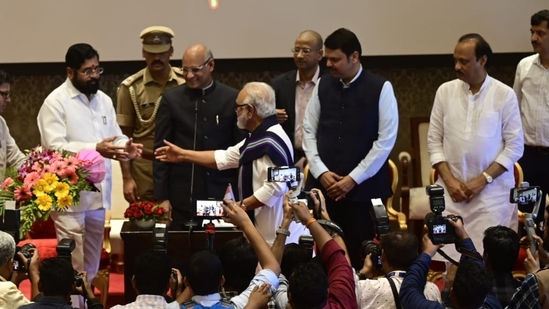 Senior NCP leader Chhagan Bhujbal greets Maharashtra chief minister Eknath Shinde after taking the oath as a minister at Raj Bhavan in Mumbai.(HT Photo/Anshuman poyrekar)