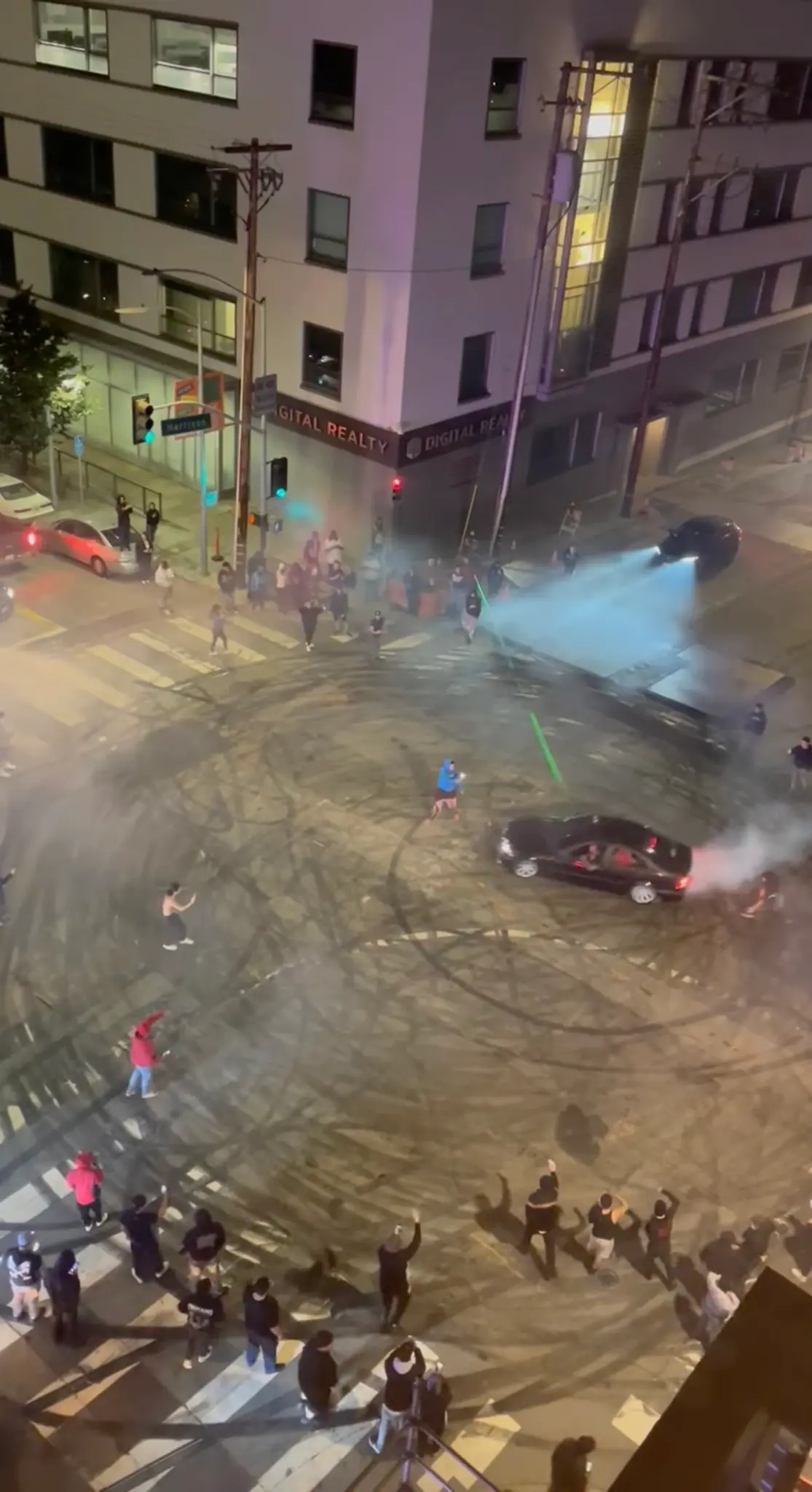 Sideshow cars burn rubber and leave skid marks in a blocked Oakland intersection(Mrinali Goyal via Storyfu) Sideshow cars burn rubber and leave skid marks in a blocked Oakland intersection(Mrinali Goyal via Storyfu)