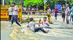 A man clicks a picture while others enjoy and bathe in floodwaters near Shantivan on Friday. (Raj K Raj/HT) A man clicks a picture while others enjoy and bathe in floodwaters near Shantivan on Friday. (Raj K Raj/HT)