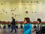 In this file photo, visitors walk past a wall with a map showing the Belt and Road Initiative (BRI) countries, at an exhibition in Beijing, (REUTERS) In this file photo, visitors walk past a wall with a map showing the Belt and Road Initiative (BRI) countries, at an exhibition in Beijing, (REUTERS)
