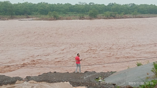 A man stands near the bank of Ghaggar river, which is in spate after heavy rainfall, in Haryana's Panchkula on Saturday. (Sant Arora/ Hindustan Times)