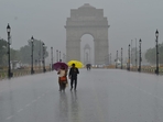 Visitors enjoying rainfall at Kartavya Path. The relative humidity ws reacorded at 85 per cent around 8:30am.(Vipin Kumar/ Hindustan Times)