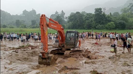 Rescue teams clearing the sludge after a cloudburst in Sirmaur on Wednesday. (HT Photo)