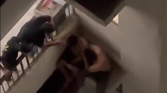 A screen grab from a video shows the two of the men on the seventh floor balcony and two sitting on the ledge, at Supertech Ecovillage 3, around midnight on Sunday. (HT Photo) A screen grab from a video shows the two of the men on the seventh floor balcony and two sitting on the ledge, at Supertech Ecovillage 3, around midnight on Sunday. (HT Photo)