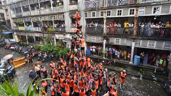 Govinda revellers build a human pyramid to reach and smash the earthen pot during the festival of Dahi Handi on Krishna Janmashtami in Parel, Mumbai. (HT photo/AnshumanPoyrekar.)