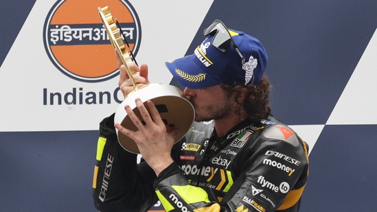 Mooney VR46 Racing Team's Marco Bezzecchi celebrates with the trophy on the podium after winning the MotoGP(REUTERS)