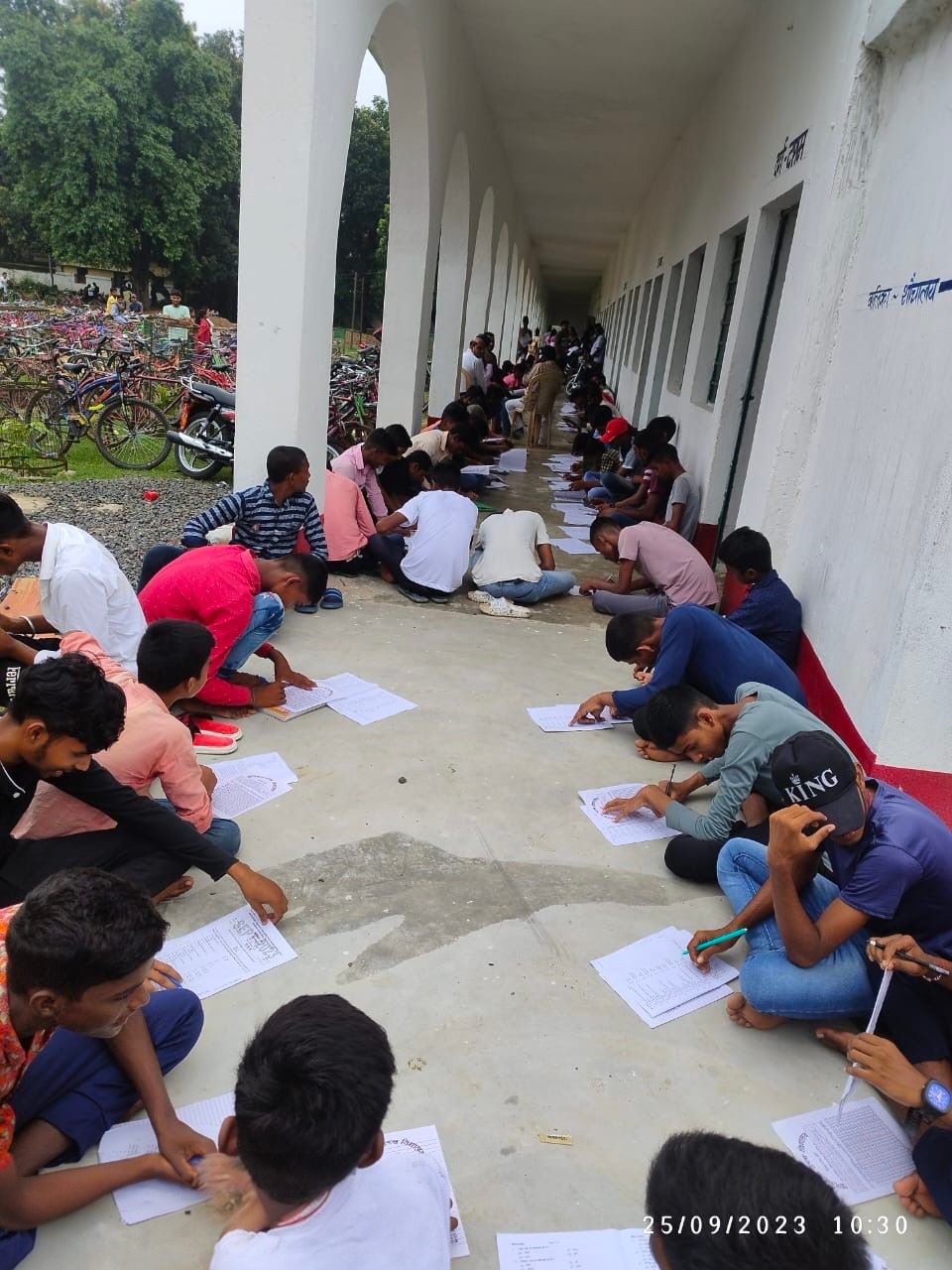 Students seen writing exam on floor(Photosourced ) Students seen writing exam on floor(Photosourced )