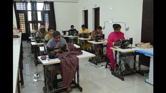 Local women stitching school uniforms at Akalgarh Pehal Hosiery centre set up by the district administration. (HT Photo) Local women stitching school uniforms at Akalgarh Pehal Hosiery centre set up by the district administration. (HT Photo)