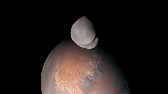 This composite image provided by the UAE Space Agency shows Mars’ moon Deimo in the foreground. A spacecraft around Mars has ventured closer to the red planet’s little moon Deimos than any human-made object in history. The United Arab Emirates’ Hope spacecraft flew within 62 miles of Deimos last month. (UAE Space Agency via AP) (AP) This composite image provided by the UAE Space Agency shows Mars’ moon Deimo in the foreground. A spacecraft around Mars has ventured closer to the red planet’s little moon Deimos than any human-made object in history. The United Arab Emirates’ Hope spacecraft flew within 62 miles of Deimos last month. (UAE Space Agency via AP) (AP)