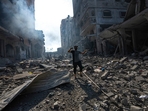 A Palestinian walks through the destruction due to Israeli strikes on Gaza. (AP) A Palestinian walks through the destruction due to Israeli strikes on Gaza. (AP)