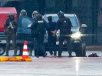 A man is led away by the police outside Germany's Hamburg airport. (AP) A man is led away by the police outside Germany's Hamburg airport. (AP)