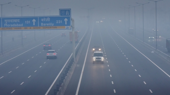 Commuters out on a smoggy morning amid rising air pollution levels at Delhi Meerut Expressway. 