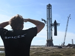A person looks on as SpaceX's huge Super Heavy-Starship is unstacked from the booster as it sits on the launchpad at Starbase in Boca Chica, Texas, on November 16, 2023, ahead of its second test flight posponed to November 18. (AFP) A person looks on as SpaceX's huge Super Heavy-Starship is unstacked from the booster as it sits on the launchpad at Starbase in Boca Chica, Texas, on November 16, 2023, ahead of its second test flight posponed to November 18. (AFP)