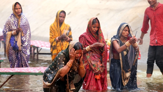 Chhath Puja participants gather at the Sirhind canal in Bathinda, Punjab, to perform rituals at sunset on Sunday.(Sanjeev Kumar/HT Photo)