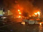 Flames rise from the car and a bus, set alight at the junction of Bachelors Walk and the O'Connell Bridge, in Dublin. (AFP) Flames rise from the car and a bus, set alight at the junction of Bachelors Walk and the O'Connell Bridge, in Dublin. (AFP)