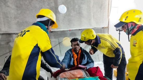 A worker is surrounded by SDRF personnel after his rescue from inside the Silkyara tunnel in Uttarkashi district of Uttarakhand. (Sourced image) A worker is surrounded by SDRF personnel after his rescue from inside the Silkyara tunnel in Uttarkashi district of Uttarakhand. (Sourced image)