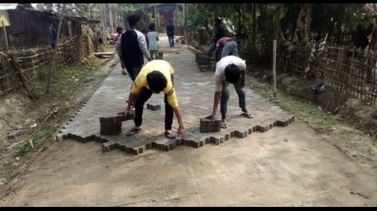 Interlocking tiles being laid in a bylane by workers (For representation only) Interlocking tiles being laid in a bylane by workers (For representation only)