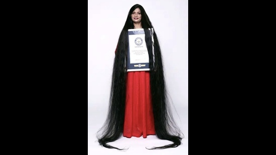 Smita proudly displaying her long tresses while holding the Guinness World Records certificate. (Sourced) Smita proudly displaying her long tresses while holding the Guinness World Records certificate. (Sourced)