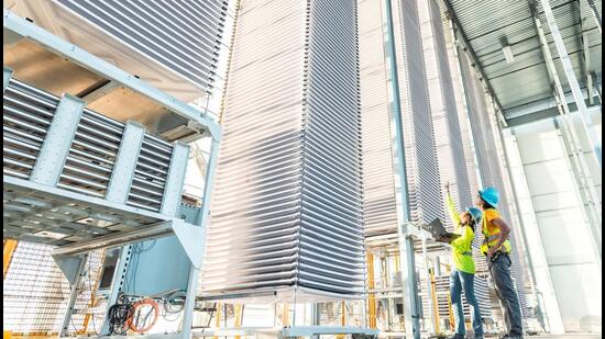 A person points at a stack of trays holding treated limestone, used to absorb CO2 from the air, at Heirloom's new plant, in Tracy, California, on November 9. (REUTERS) A person points at a stack of trays holding treated limestone, used to absorb CO2 from the air, at Heirloom's new plant, in Tracy, California, on November 9. (REUTERS)