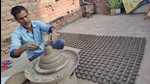 A potter busy making earthen lamps in Prayagraj. (HT Photo) A potter busy making earthen lamps in Prayagraj. (HT Photo)