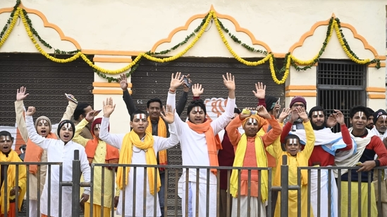 As the invitees arrived, locals and devotees gathered on both sides of the road, waving saffron flags and dancing to songs dedicated to Lord Ram. (HT Photo/Deepak Gupta)