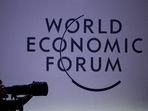 A press photographer works next to the logo of the World Economic Forum (WEF) at the opening of their annual meeting in Davos on January 15, 2024. (AFP) A press photographer works next to the logo of the World Economic Forum (WEF) at the opening of their annual meeting in Davos on January 15, 2024. (AFP)