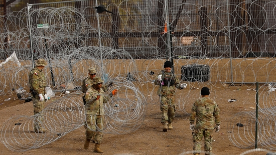 Members of the Texas National Guard place razor wire near the fence on the border with Mexico to inhibit the crossing of migrants into the U.S., as seen from Ciudad Juarez, Mexico January 23, 2024. REUTERS/Jose Luis Gonzalez(REUTERS)