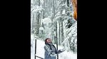 A tourist enjoys during snowfall at Patnitop in Udhampur on Tuesday. (ANI) A tourist enjoys during snowfall at Patnitop in Udhampur on Tuesday. (ANI)