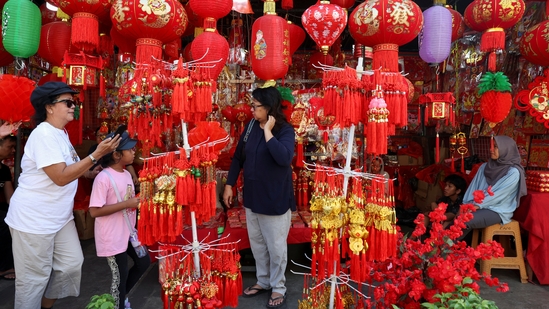 People stand next to a street market stall selling decorations ahead of the Lunar New Year in Jakarta, Indonesia, February 8, 2024. REUTERS/Ajeng Dinar Ulfiana(REUTERS)