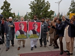 Pakistan's newly elected lawmakers displays a poster of their leader and imprisoned former Prime Minister Imran Khan as they arrive to attend opening session of the Parliament, in Islamabad, Pakistan. (AP) Pakistan's newly elected lawmakers displays a poster of their leader and imprisoned former Prime Minister Imran Khan as they arrive to attend opening session of the Parliament, in Islamabad, Pakistan. (AP)