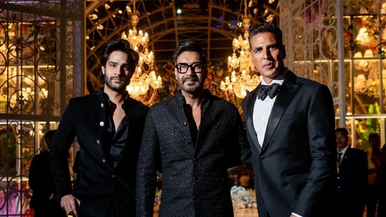 The first day at Anant Ambani and Radhika Merchant's three-day pre-wedding fanfare in Jamnagar was a hit. Several Bollywood stars, international personalities and more took part in An Evening in Everland party. Here Ajay Devgn and his nephew are posing for pictures with Akshay Kumar. Most men turned up in black suits for the night. 